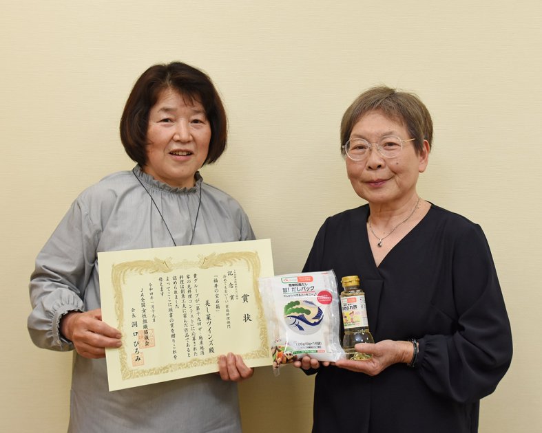 賞状と副賞を手にする「美し菜ツインズ」の辻本昌江さん㊧と田中邦恵さん㊨